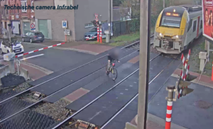 Teen cyclist rides across level crossing in Belgium