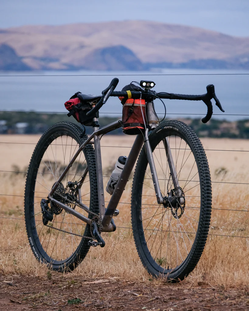 Curve Cycling Titanosaur gravel bike on landscape background
