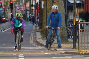 Cyclists in London talking in cycle lane – copyright Simon MacMichael