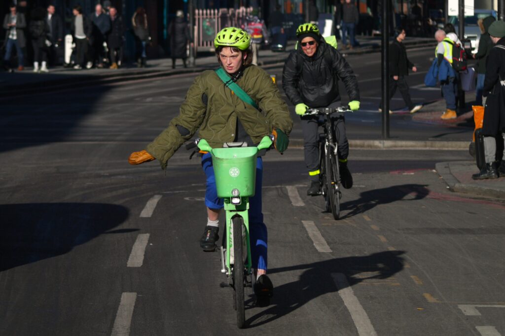 Cyclist in London indicating in cycle lane – copyright Simon MacMichael