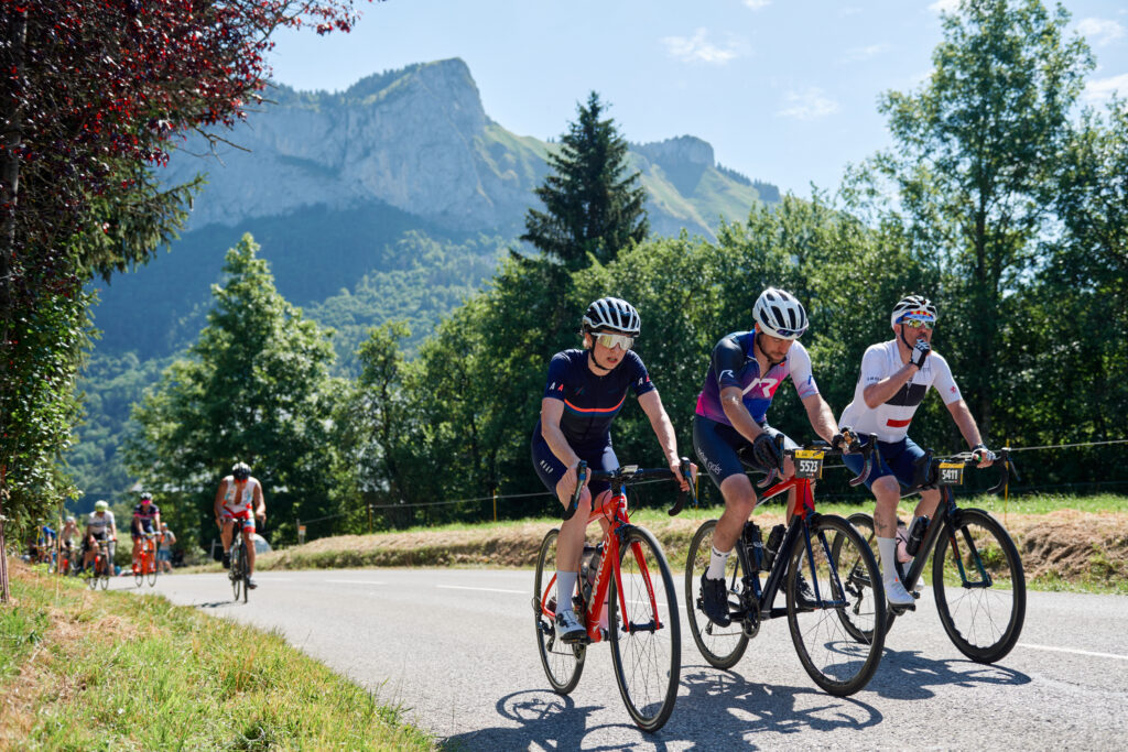 L’Étape du Tour cyclists ride a climb in the Alps