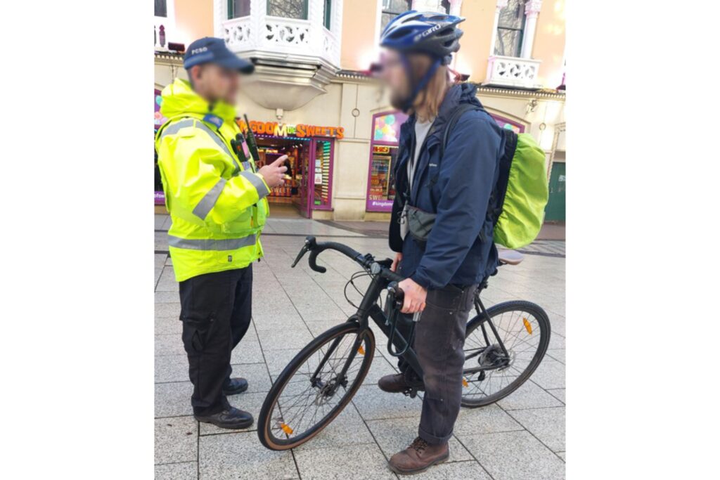 PCSO stopping a cyclist, Cardiff Queen Street (Cardiff City Council, Twitter)
