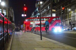 Cyclists in London at night stopped at red light – copyright Simon MacMichael