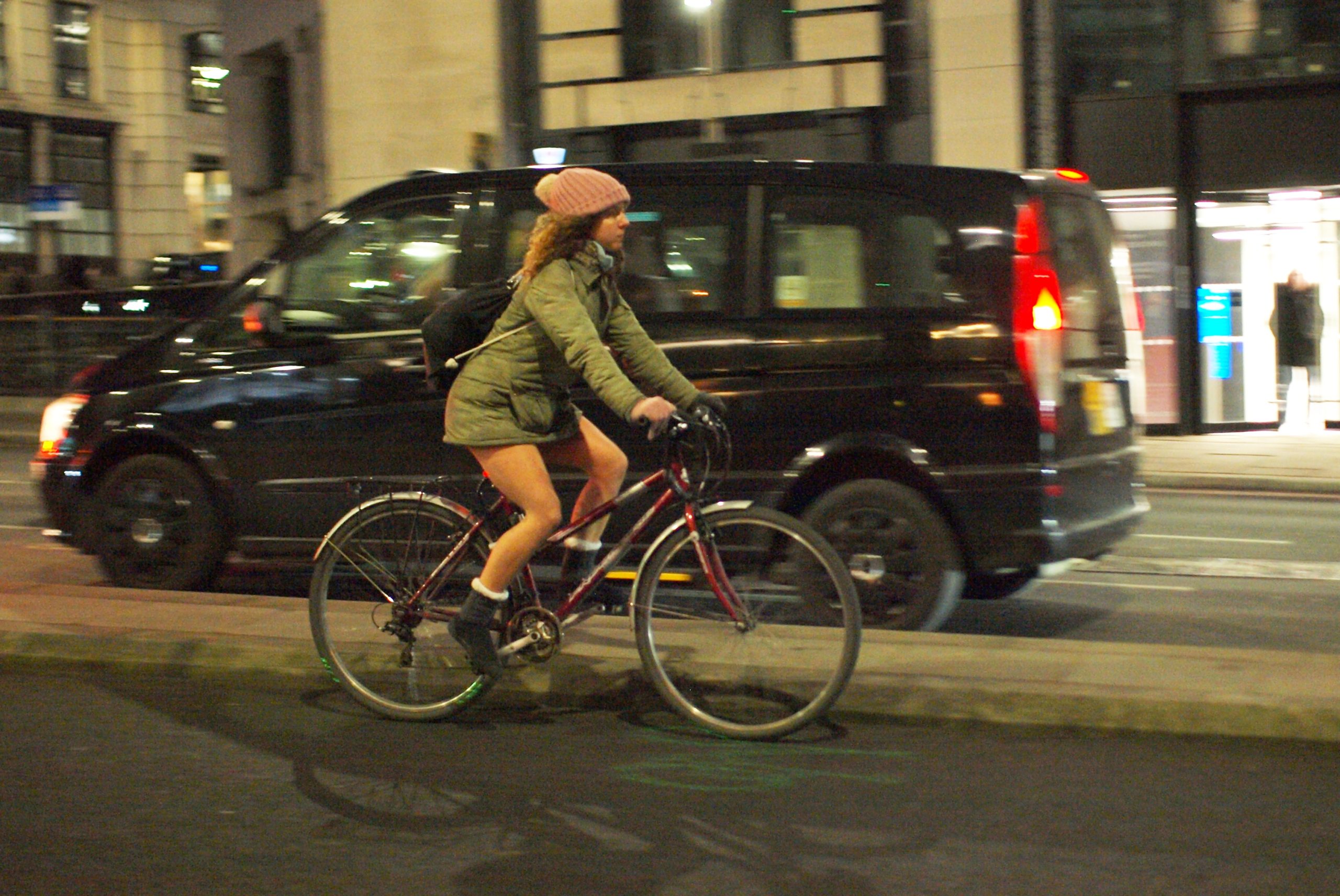 Female cyclist in London casual winter clothing on hybrid bike - copyright Simon MacMichael