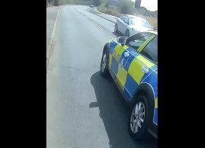 Police car close passing cyclist in Gloucestershire