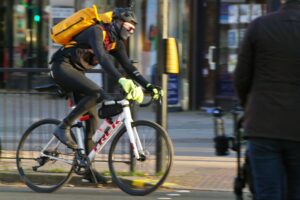 Cyclist in London Trek road bike orange backpack and winter clothing – copyright Simon MacMichael