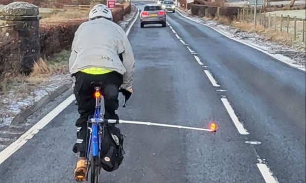 Cyclist with close pass pole, Perth and Kinross
