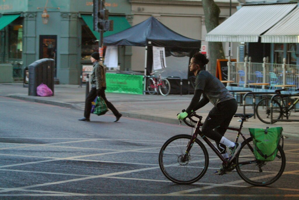 Cyclist in London on road bike with panniers &ndash; copyright Simon MacMichael