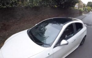 Driver mounts pavement to overtake cyclist