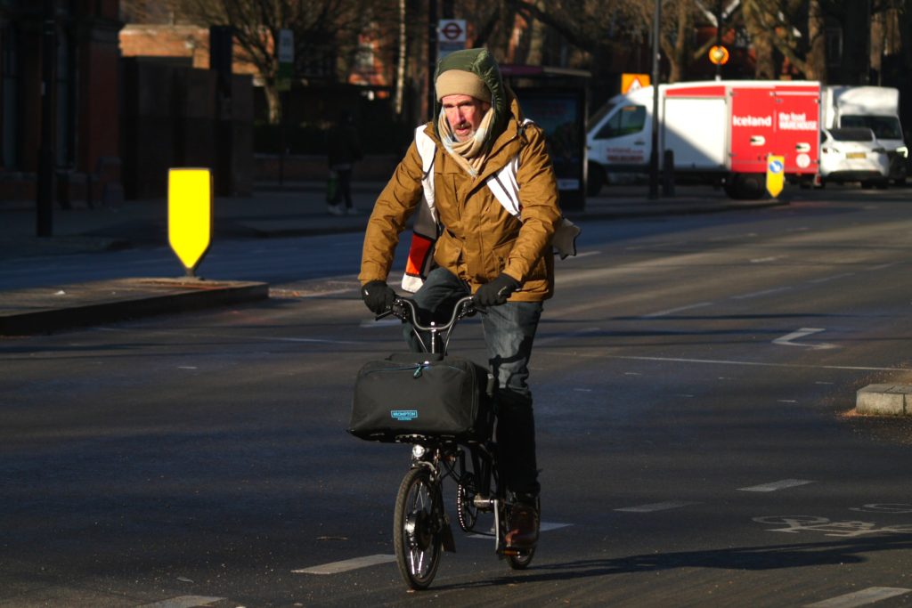 Cyclist in London electric Brompton and winter clothing – copyright Simon MacMichael