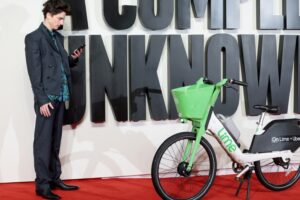 Timothée Chalamet parks Lime bike at London premiere of A Complete Unknown