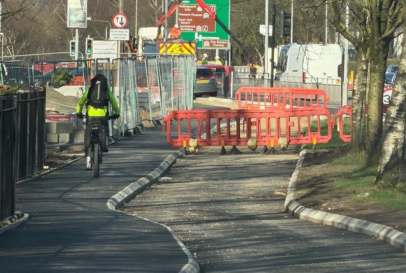 Cyclist riding next to incomplete cycle lane
