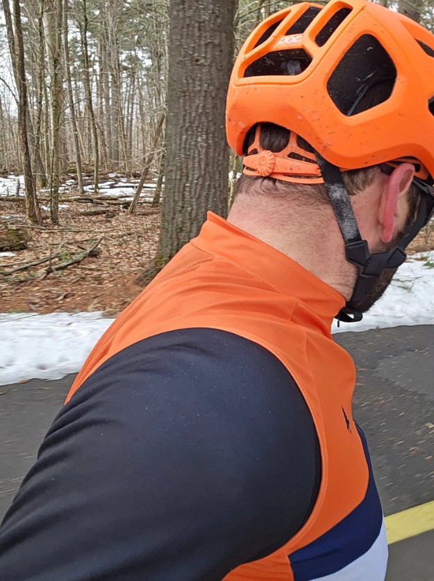 Cyclist in orange gilet and helmet almost hit by driver