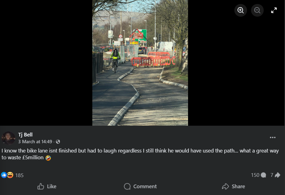 Cyclist riding next to incomplete cycle lane