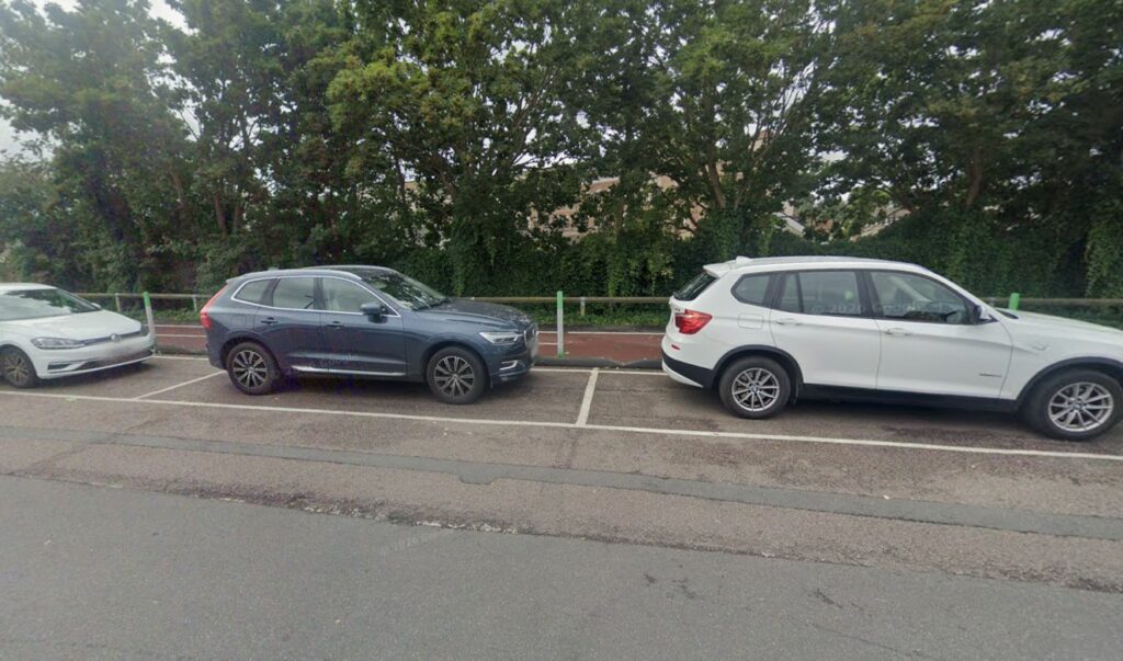 Cars parked next to Vineyard Road cycle lane, Colchester