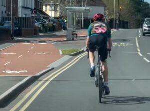 Cyclist riding on road beside cycle lane annoys driver