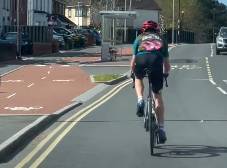Cyclist riding on road beside cycle lane annoys driver