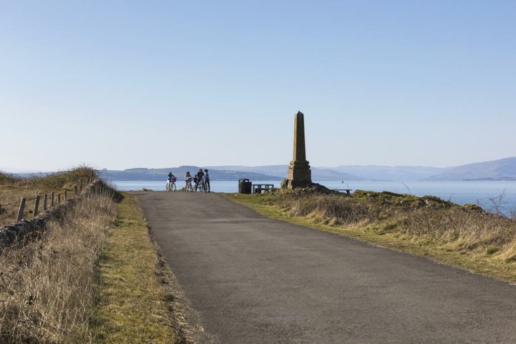 Cyclists at Tomont End Monument, Cumbrae