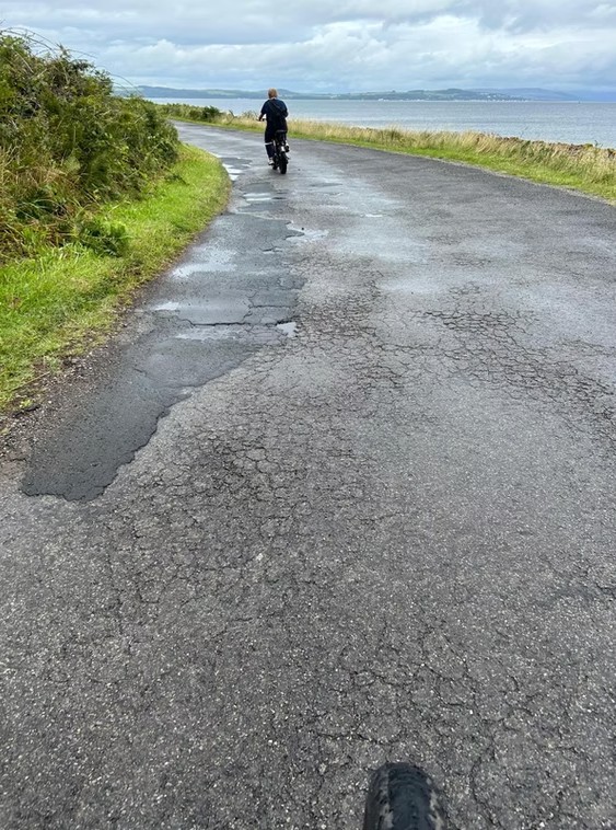 Cyclists on rural road in Cumbrae