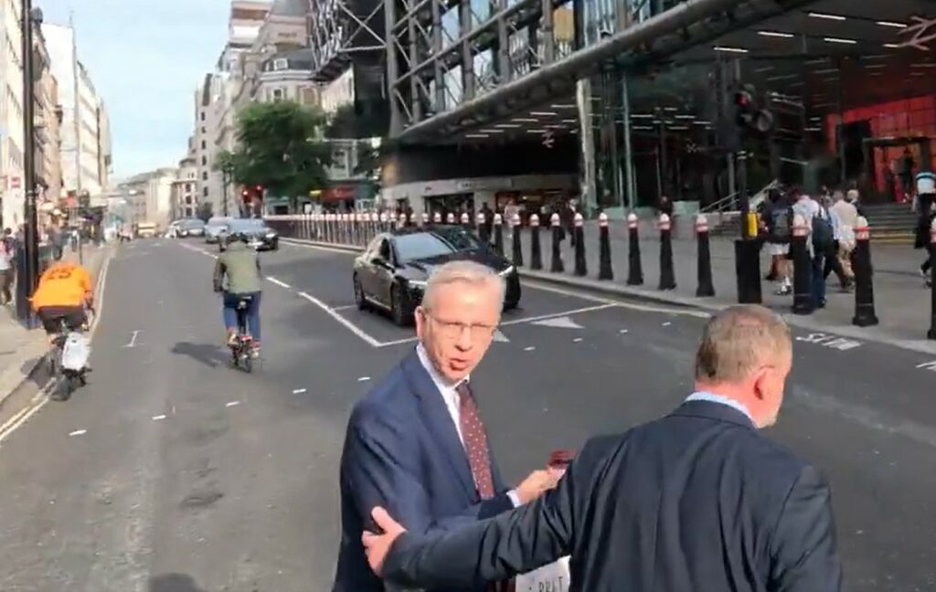 Cyclist almost collides with Michael Gove at crossing