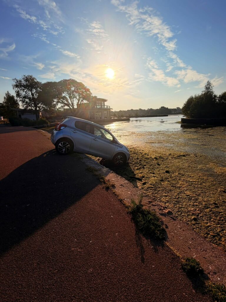Car wedged in Poole Park lake