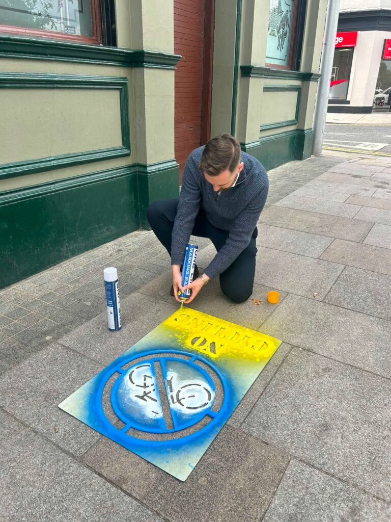 Kyle Moutray spraying 'no cycling' sign on pavement in Portadown