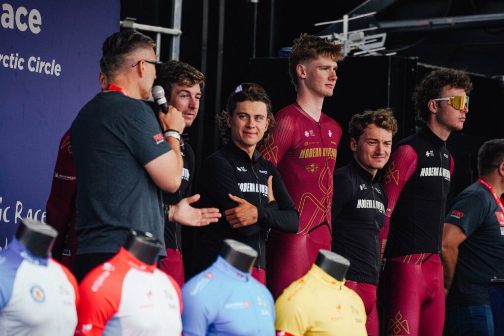 Ezra Caudell (without a jacket) alongside his Modern Adventure teammates at the 2026 Arctic Race of Norway