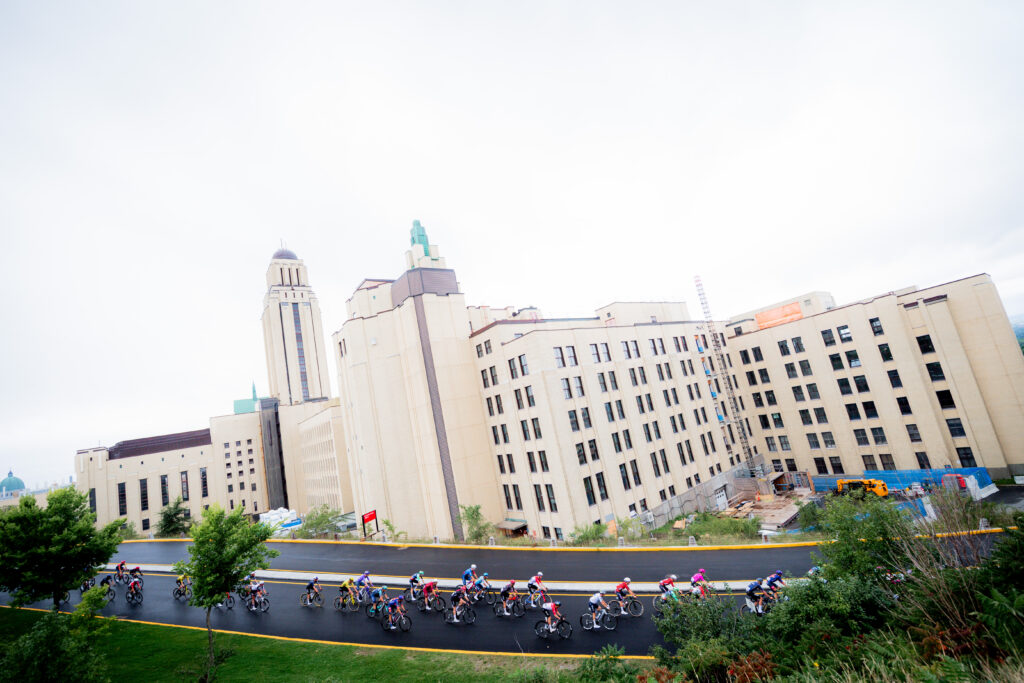 Peloton passes the Polytechnique Montréal, 2026 Grand Prix Cycliste de Montréal
