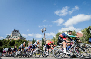 The peloton rides underneath Le Château Frontenac, 2026 Grand Prix Cycliste de Québec