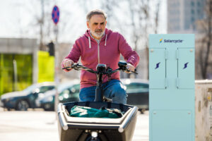 Cargo e-bike cyclist with SolarPoint charging pillar