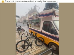 Bike parked on cycle rack blocks ice cream van door
