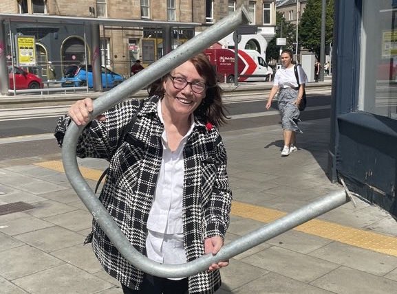 Cllr Rae lifting the bike racks in Edinburgh
