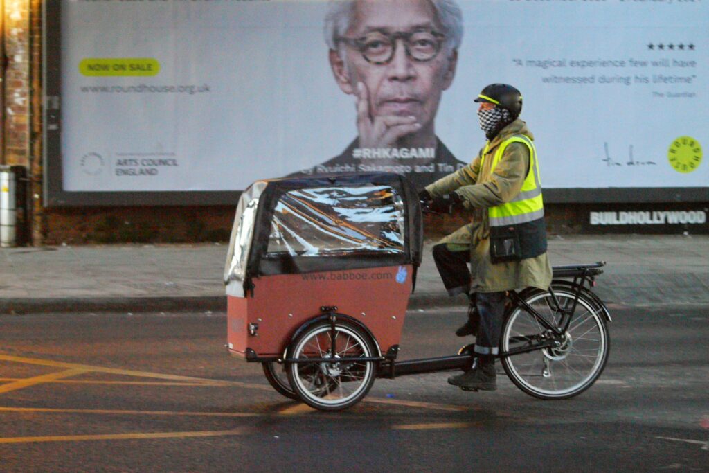 Cyclist in London hi-vis with cargo bike