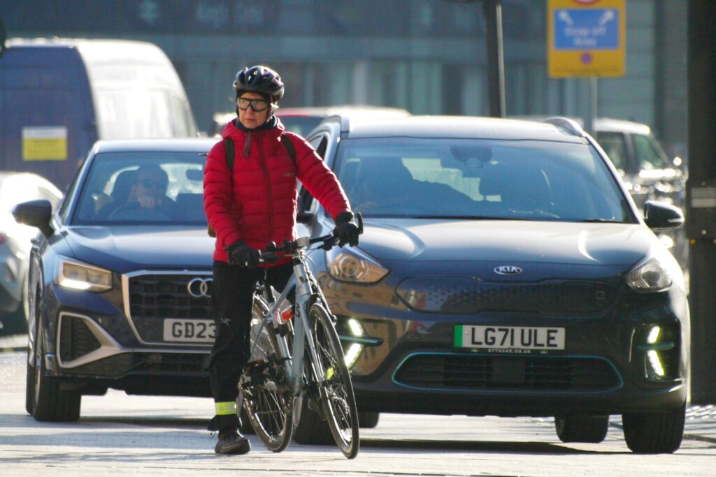 Cyclist in London sropped in traffic with cars in background &ndash; copyright Simon MacMichael