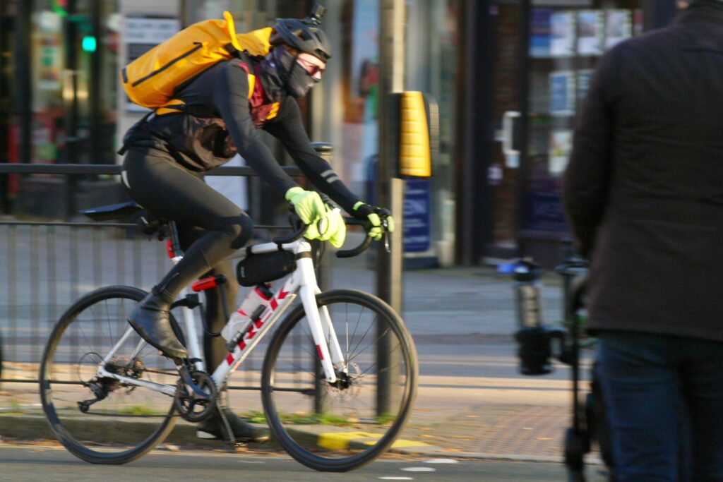 Cyclist in London Trek road bike orange backpack and winter clothing &ndash; copyright Simon MacMichael