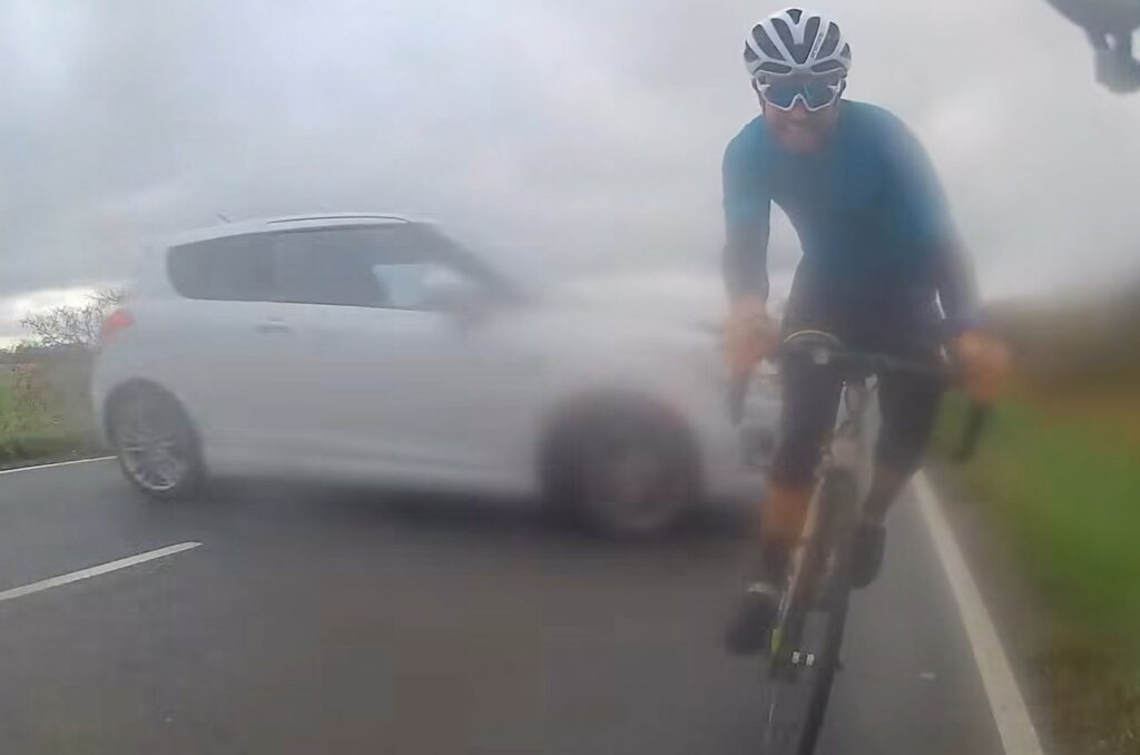 Cyclist narrowly avoids being hit by sideways driver