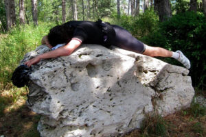 Cyclist exhausted on a rock