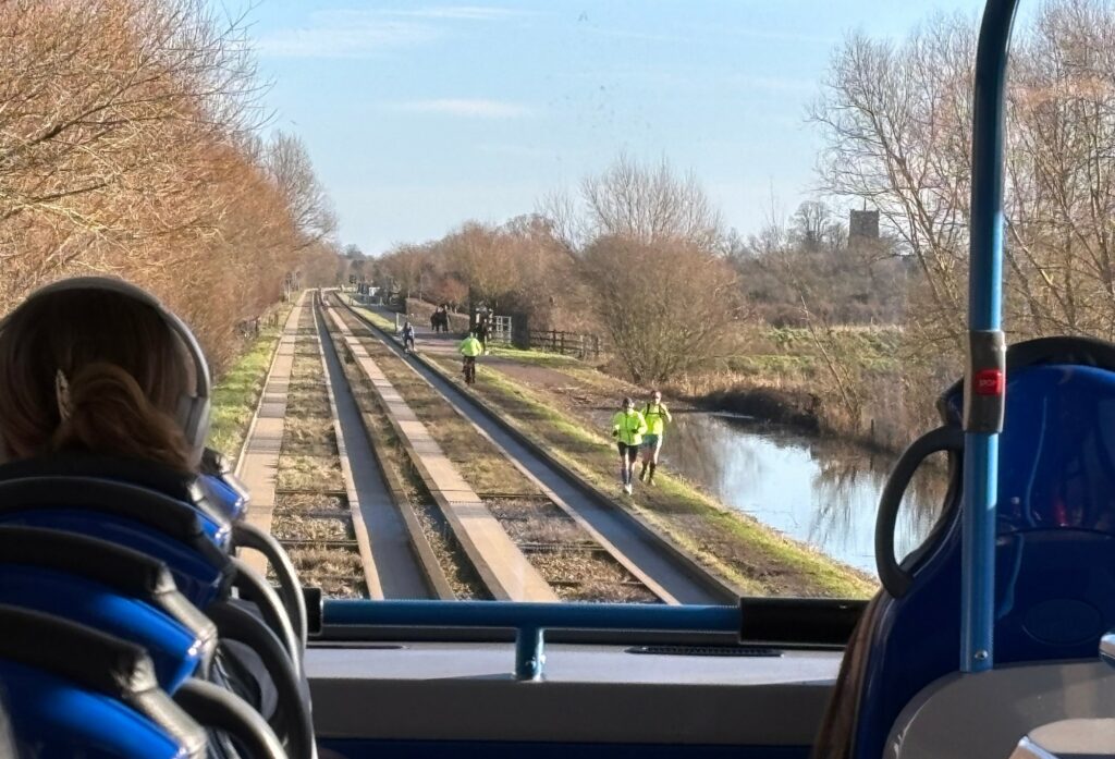 Cyclists and runners on DIY path next to Cambridgeshire Guided Busway