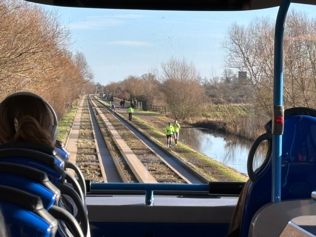 Cyclists and runners on DIY path next to Cambridgeshire Guided Busway