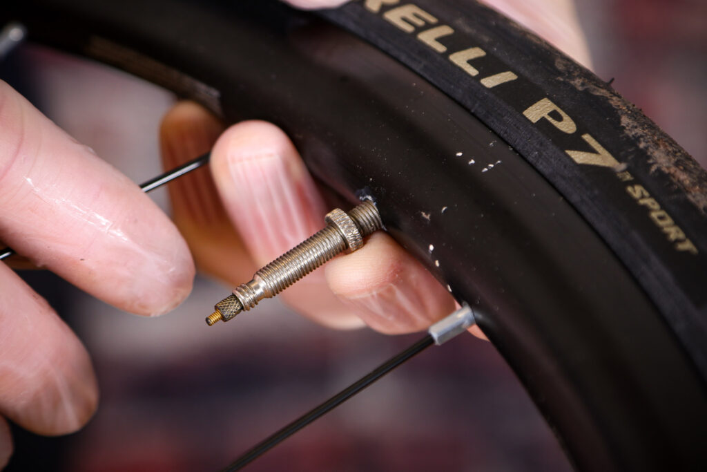 Fitting an inner tube &ndash; 01 &ndash; removing valve collar and deflating tyre
