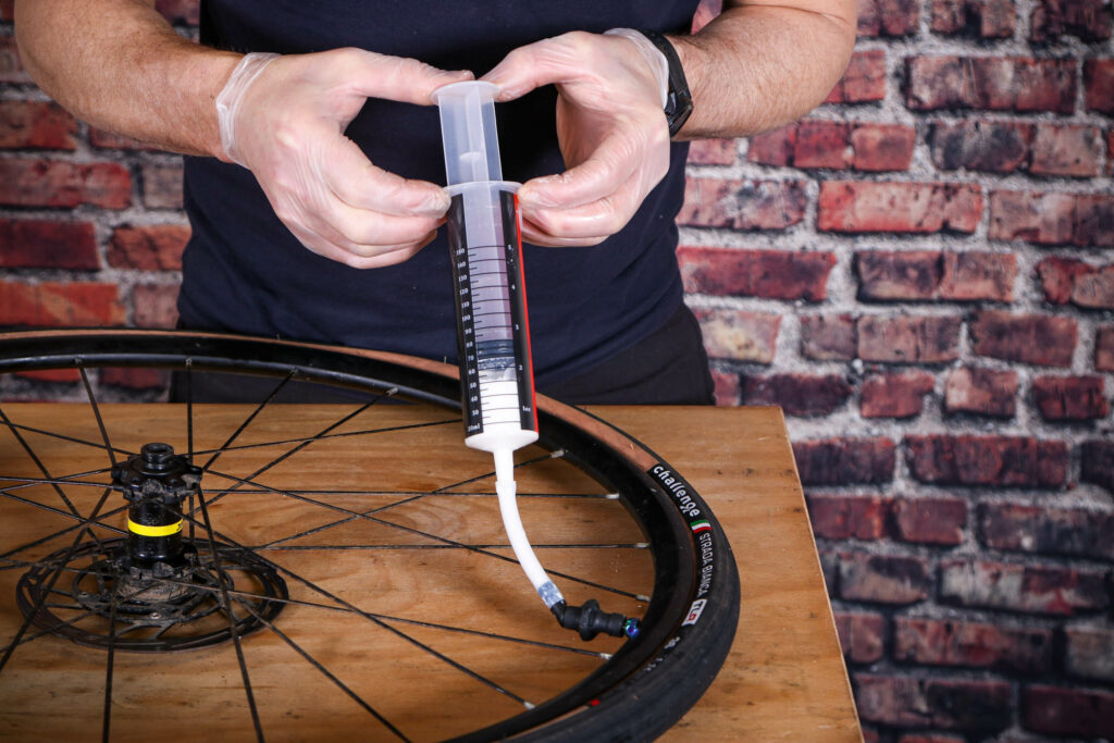 Fitting tubeless tyres – 21 – insert sealant through valve body