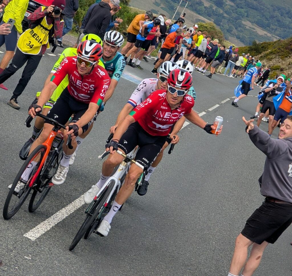 Geraint Thomas accepting a beer from a spectator at 2025 Tour of Britain