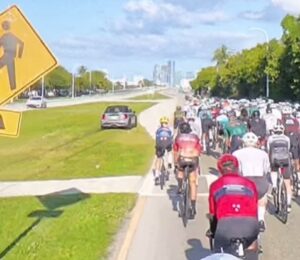 Mini driver overtakes group of cyclists on grass in Miami