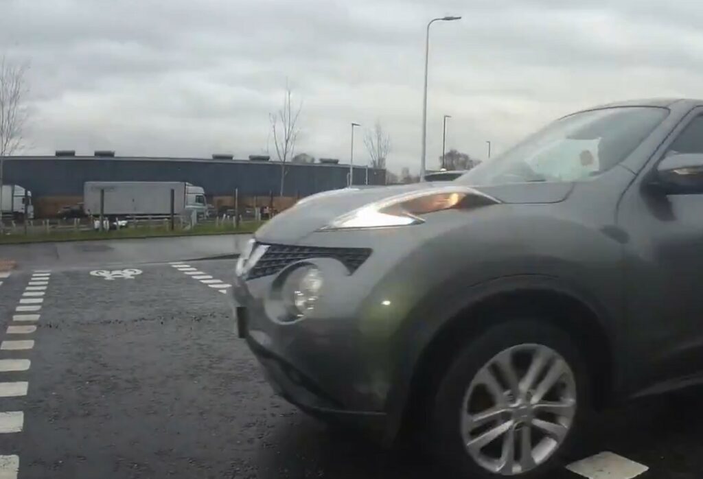 Motorist drives through cyclists parallel crossing