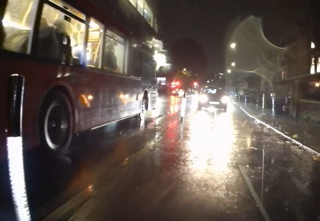 Motorist drives towards cyclists in cycle lane, Lower Road towards Surrey Quays, London
