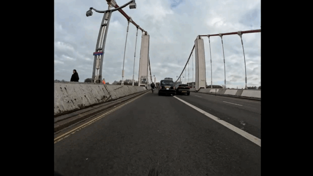 Near Miss of the Day 926: taxi squeezing between cyclists and drivers