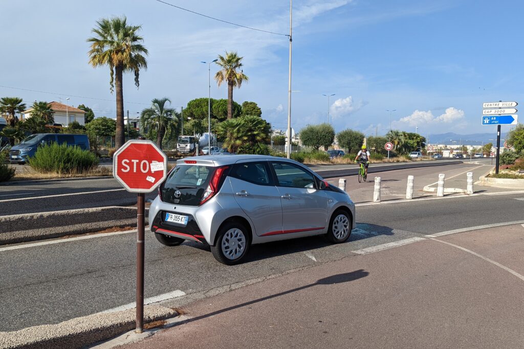 Nice-Antibes – Cycle path junction with car (copyright Simon MacMichael)