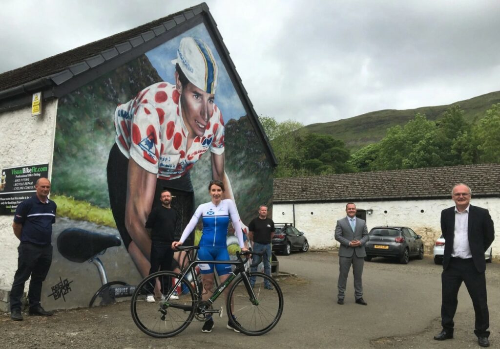 Pippa York beside a mural dedicated to her in Lennonxtown