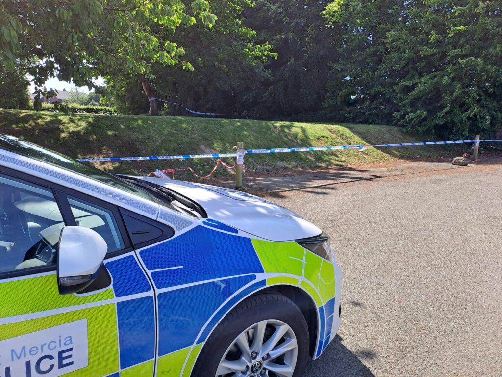 Police tape off grass bank in Baschurch village hall grounds used by young cyclists