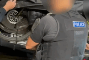 Cyclists fined over migrant in bike rack